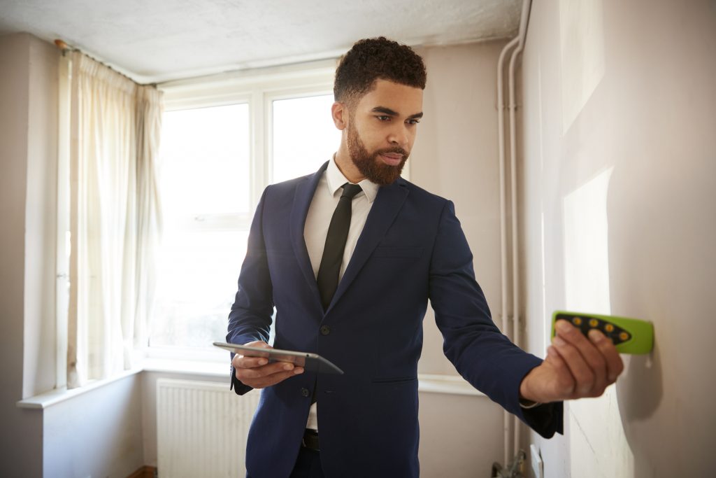 Design Consultant using a laser measuring tool 