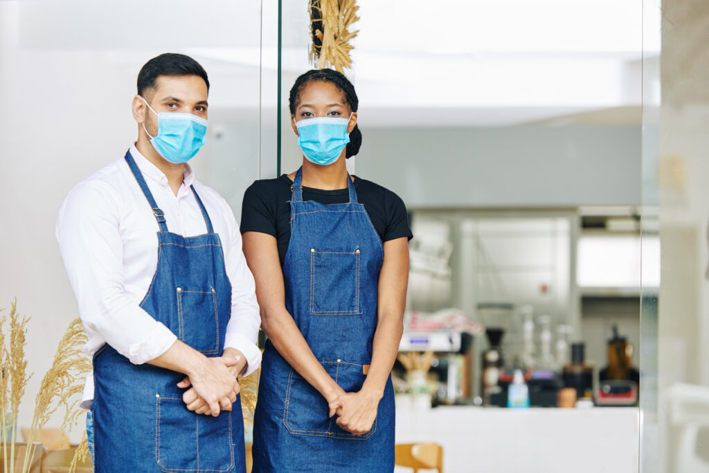 workers at a small local business wearing masks