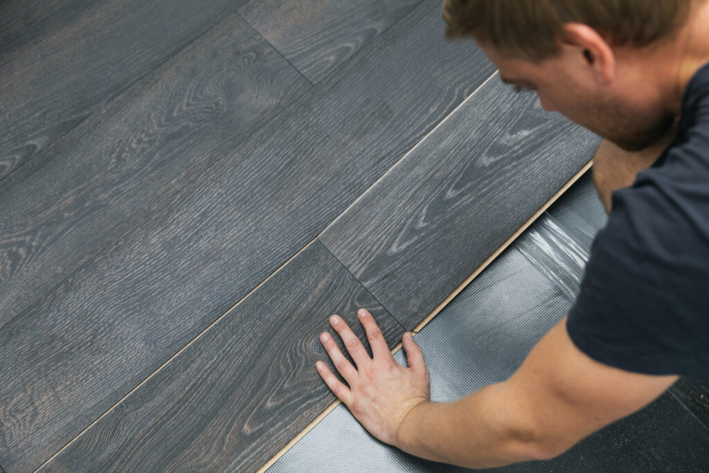 installer putting in laminate planks